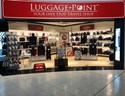 Luggage point store entrance with red signage and stock 