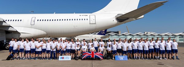 Photo of Team UK at Birmingham Airport in front a plane 